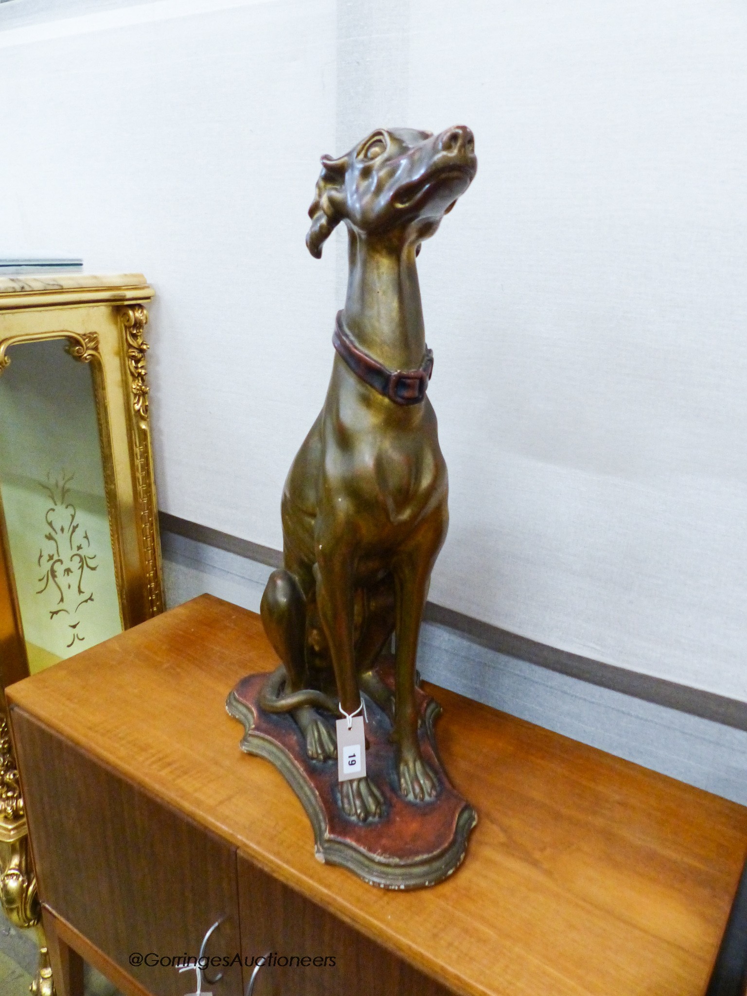 A gilt composition seated greyhound, height 78cm